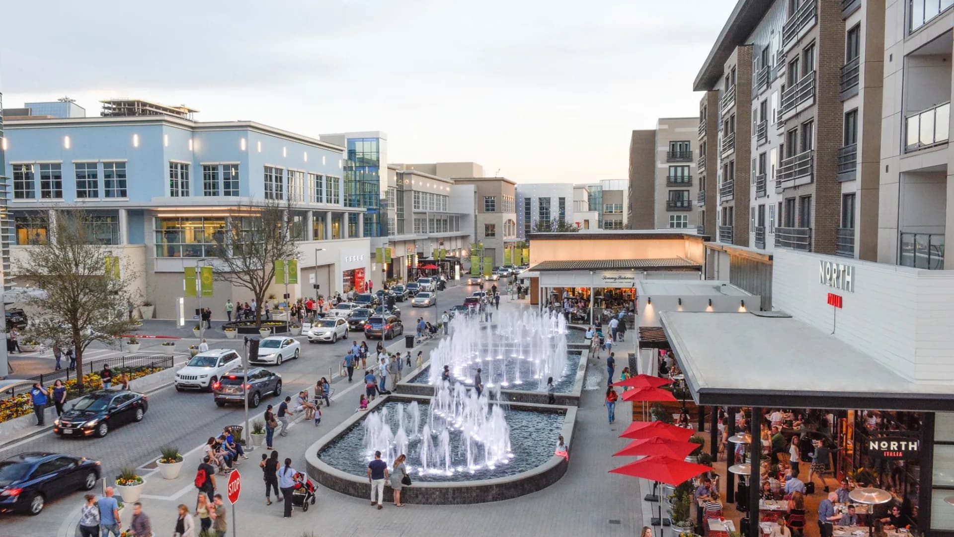 Fountains, shops, and restaurant patios at Legacy West in Plano, Texas, photographed by Amy Jacobs at dusk